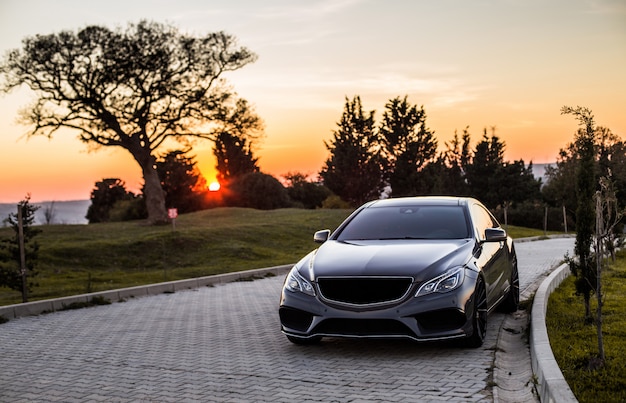grey luxury sedan car sunset 114579 4045